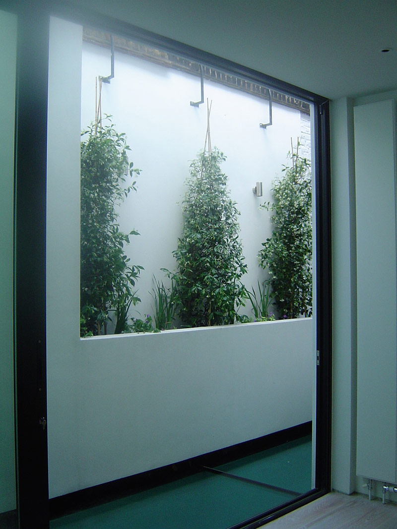 Walled shrubs on roof terrace garden in Mile End