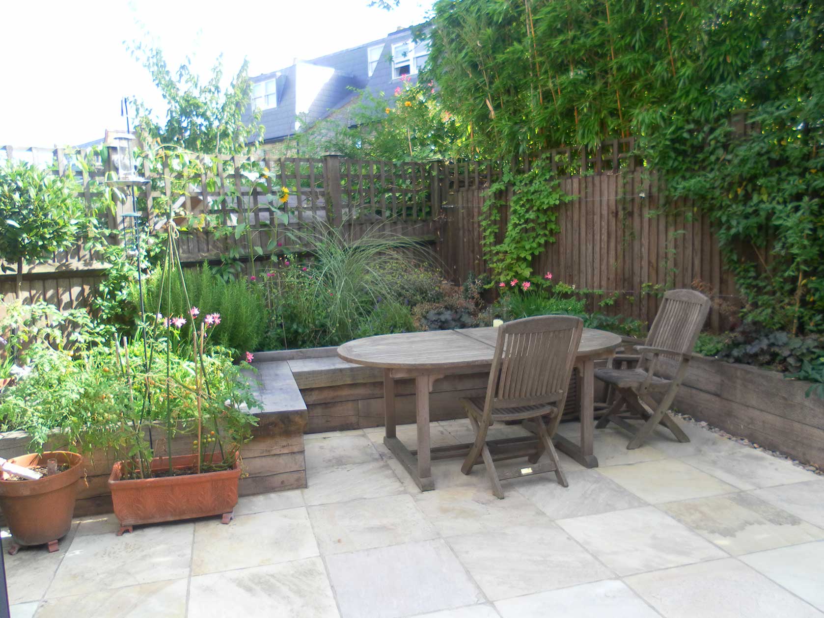 Wooden dining table and chairs in Battersea urban garden